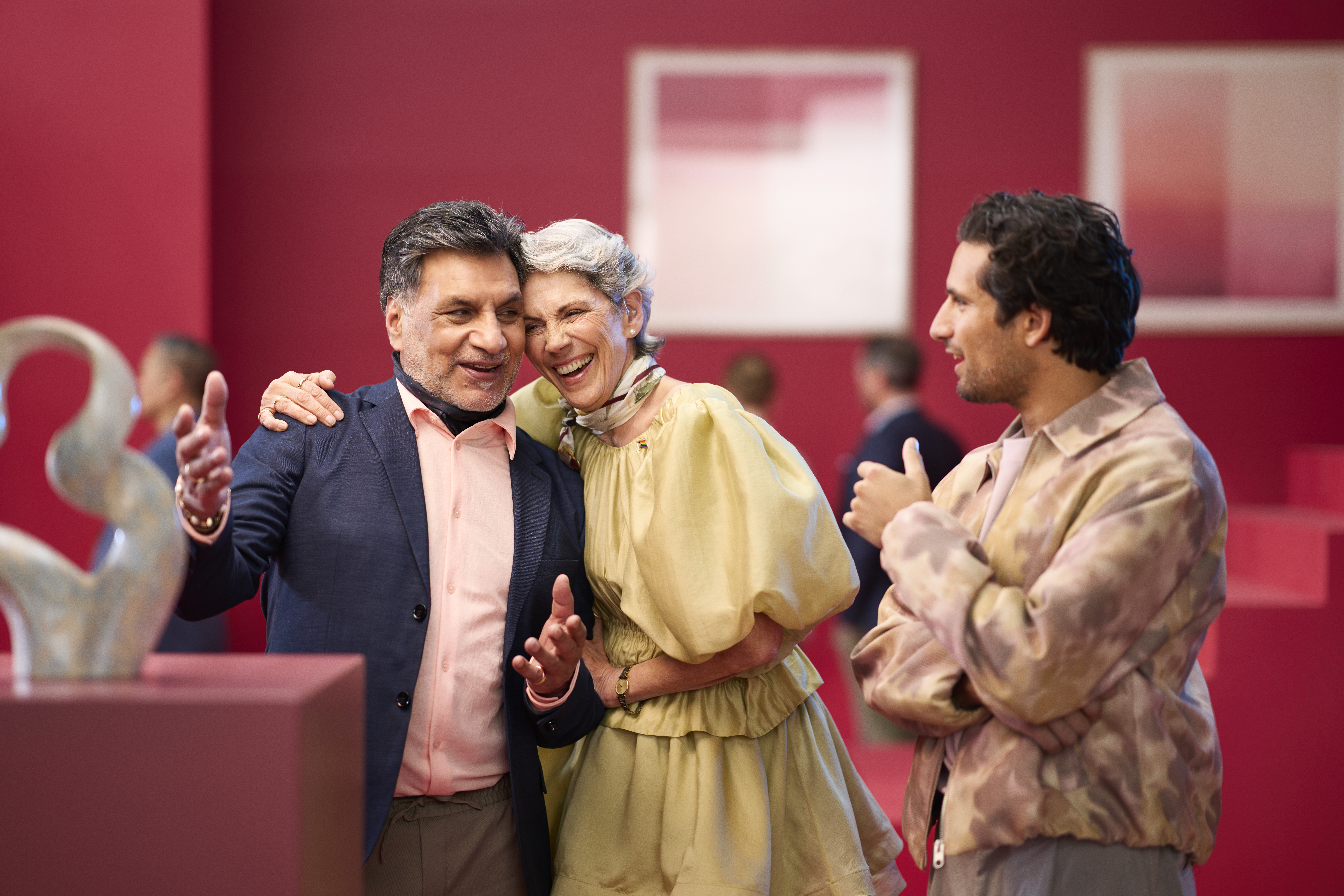 A woman picks up a hearing aid out of its charger